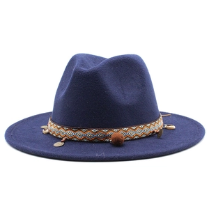 Detail of navy wool jazz hat with bohemian ethnic braided band and vintage metal coins