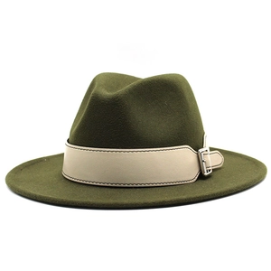 Detail of olive green fedora hat featuring a white leather band and silver metal buckle
