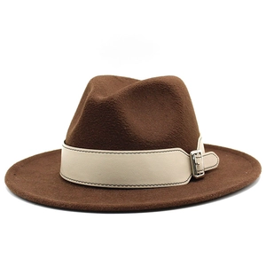 Close-up of brown wool felt fedora featuring a beige leather strap with silver buckle