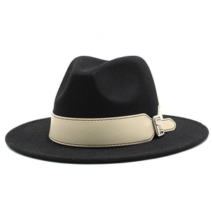 Close-up of black fedora wool hat featuring a beige leather band with metal buckle detail