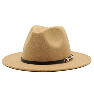 Detail of camel wool fedora hat featuring a black slim band and gold metal buckle accent