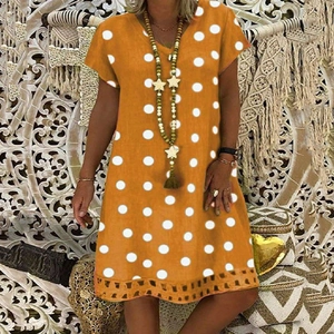 Detail of V-neck short sleeve polka dot dress in orange and white boho style