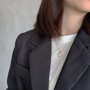 S925 silver sun moon pearl necklace in gold finish worn with a chic black blazer