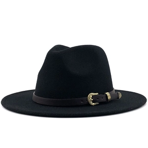 Detail of wool fedora hat featuring a brown leather band and ornate gold buckle