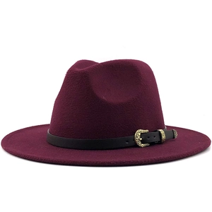 Detail of burgundy wool fedora featuring black leather band and gold metal buckle