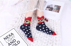Close-up of cotton socks featuring a cartoon owl pattern and blue polka dots design