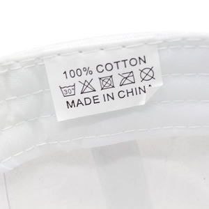 Detail view of the 100% cotton material tag and quality stitching on the white baseball cap