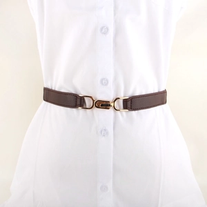 Minimalist brown elastic waist belt with gold metal buckle on a white dress shirt