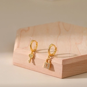 18K gold plated lock and heart key earrings featuring micro-pave cubic zirconia on wood block