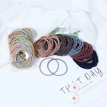 Detailed view of colorful satin oversized hair scrunchies in bulk and retail packaging
