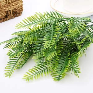 Close-up of realistic faux eucalyptus leaves in a woven basket for home decoration