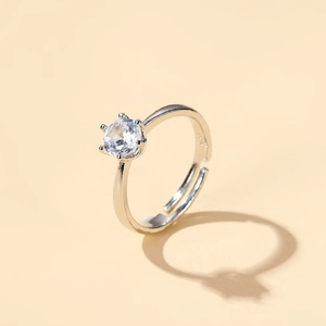 Close-up of a classic six-prong silver crown ring with a clear zircon stone