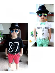 Close-up of children's summer T-shirt sets with red shorts and green polka dot pants