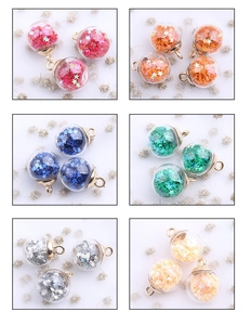 Macro detail of various colorful star-sequin glass ball pendants for DIY jewelry crafts
