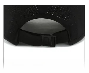 Close-up of adjustable buckle and breathable mesh fabric on black baseball cap