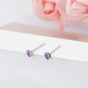 Close-up of 3mm heart-shaped S925 sterling silver stud earrings with purple stones.