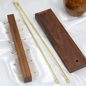 Solid walnut wood jewelry display stand with eight gold metal hooks and rectangular base
