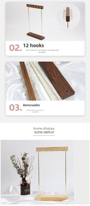 Detail of wooden jewelry stand with 12 brass hooks for necklaces and bracelets