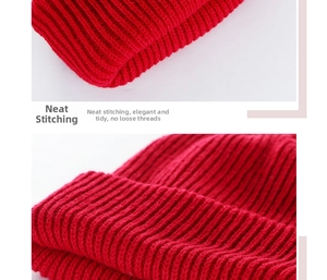 Detailed view of the red ribbed knit beanie showing fine stitching and elastic texture