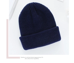 Detailed close-up of navy blue ribbed knit beanie showing high-quality warm yarn texture