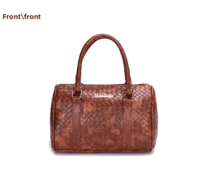 Front view of brown woven texture Boston bag featuring metal brand logo and handles