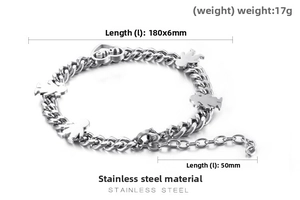 Detail of stainless steel Cuban link bracelet with heart and figure charms and measurements