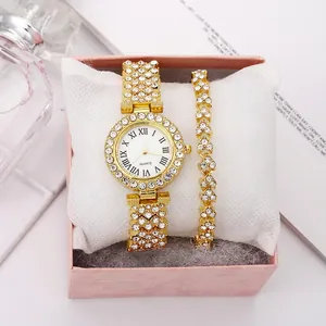 Detailed view of luxury gold quartz watch and rhinestone bracelet in a pink gift box