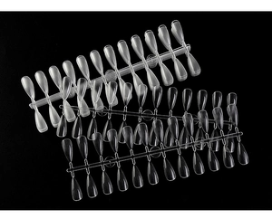 Macro shot of 240pcs clear almond shaped nail tips for extension on black background