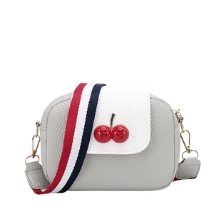 Women's small crossbody bag with cherry charm and striped strap in grey and white