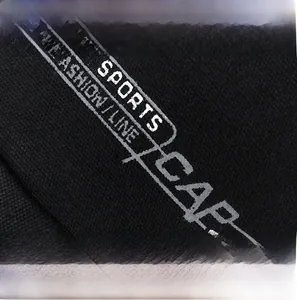 Detail of black sports cap showing premium fabric texture and white fashion typography