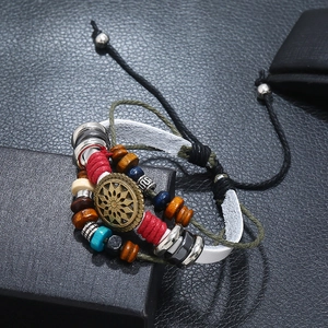 Detail view of multi-layer leather bracelet with bronze sunflower pendant and beads