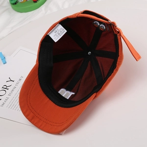 Inside view of orange cotton baseball cap for kids with M letter embroidery detail