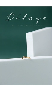 Macro shot of minimalist gold meteor ring with sparkling crystal on a white stand
