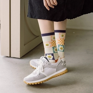Mid-calf cotton socks with checkerboard pattern and smiley sunflower in vibrant colors