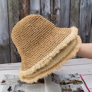 Handmade crochet straw bucket hat with frayed edges for summer sun protection in khaki