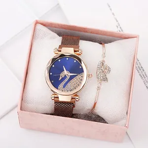 Detail view of rose gold swan watch and matching bracelet set in a luxury gift box