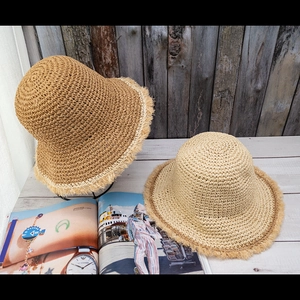 Detailed macro view of woven straw texture and stylish frayed edges on sun hats