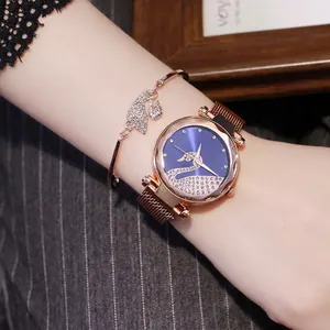 Close-up of rose gold swan watch and matching bracelet set with crystals on female wrist