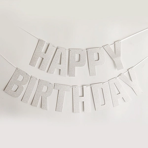 Detail of silver glitter Happy Birthday banner with shimmering texture for party decor
