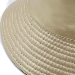 Classic leather reversible bucket hat with detailed parallel stitching on beige brim