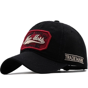 Detail of New York embroidery on black washed cotton baseball cap with vintage finish