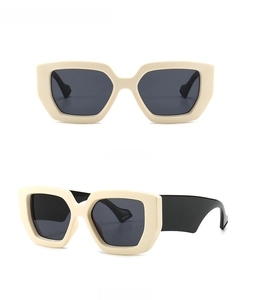 Front and 45-degree side view of oversized creamy white sunglasses with black lenses