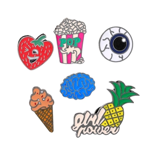 Set of six creative enamel pins featuring strawberry, popcorn, eye, ice cream, brain and pineapple