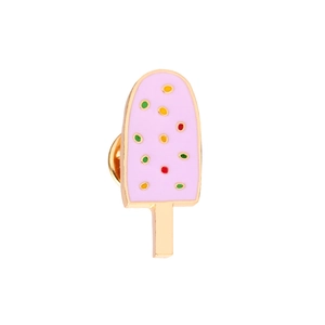 Close-up of pink ice cream enamel pin with colorful sprinkles and golden metal edges