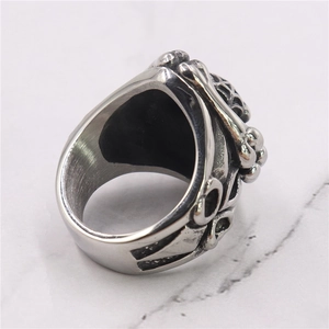 Macro shot of punk gothic skeleton ring with antique silver finish on marble surface