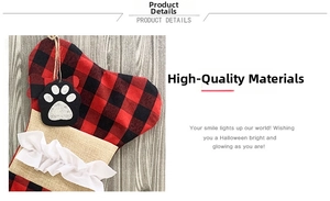 Detail of red plaid burlap Christmas dog bone stocking with white ruffled trim and paw tag