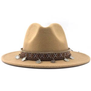 Detail of wool fedora hat featuring ethnic patterned band and vintage metal coin charms