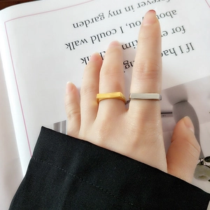 Minimalist geometric rectangular rings in gold and silver finish shown on hands