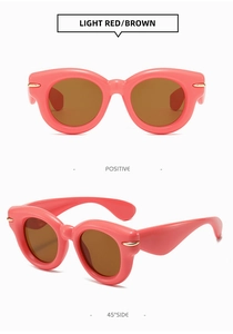Detailed front and 45-degree side views of pink round sunglasses with gold metal accents
