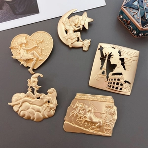 Detail view of five vintage matte gold brooches with Cupid and Roman relief designs